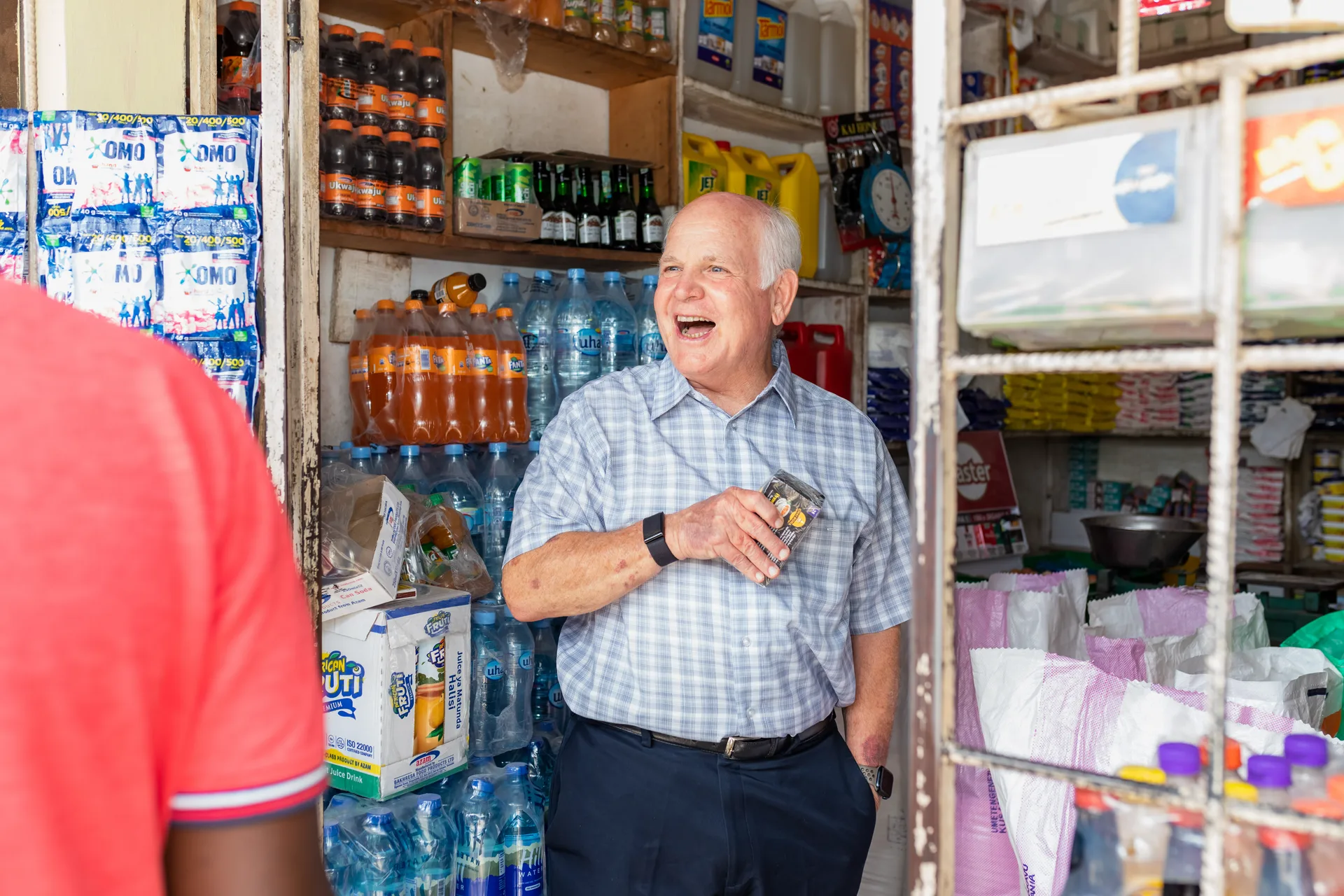 Shopkeeper serving customers in a neighbourhood retail store